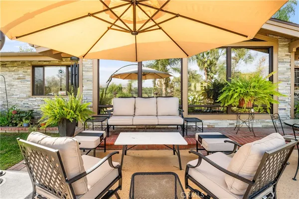 a swimming pool with outdoor seating and yard