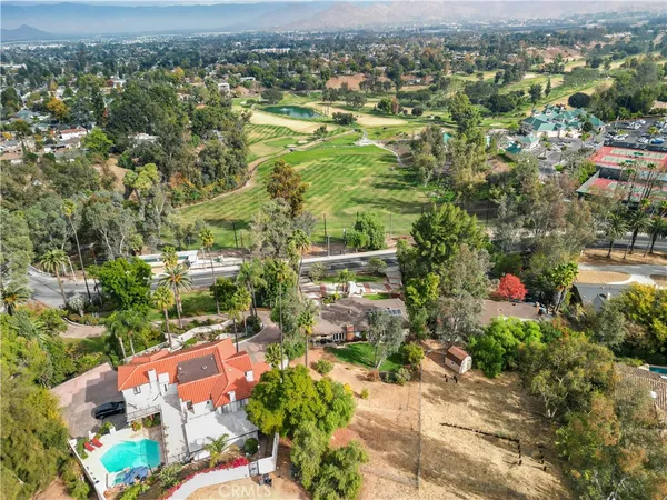a view of a garden with a lot of flower plants and wooden fence