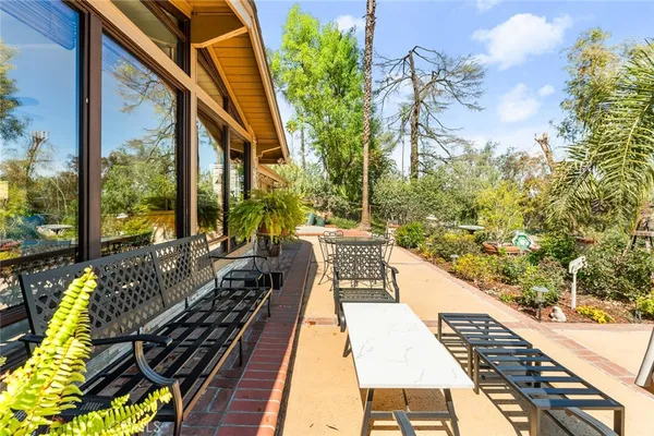 a view of balcony with wooden floor and outdoor seating