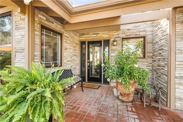 a view of a chair and table in the porch