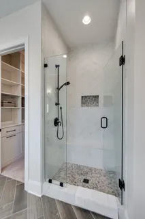 a bathroom with a glass shower door