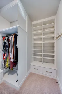 a view of walk in closet with clothes