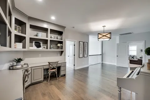 a kitchen with stainless steel appliances granite countertop a stove and a wooden floors