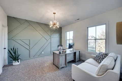 a living room with furniture and a chandelier