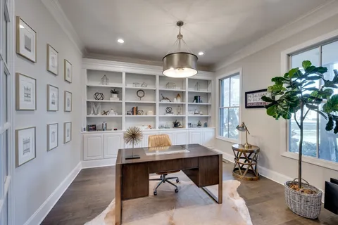 a workspace with furniture window and wooden floor