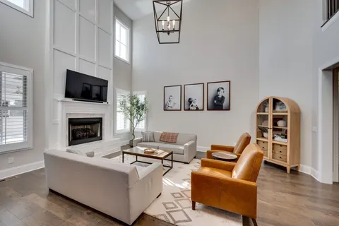 a living room with furniture a flat screen tv and a fireplace