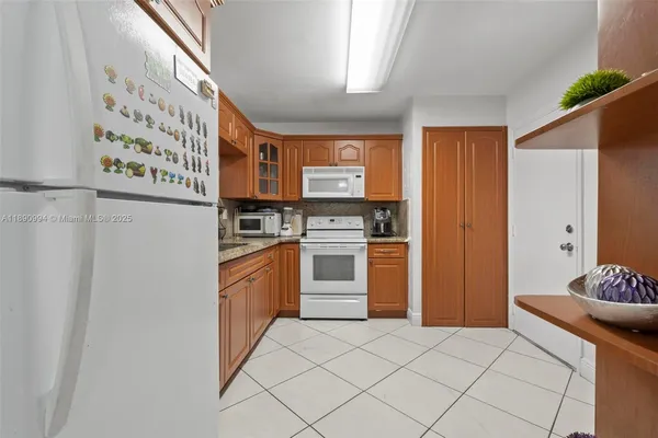 a kitchen with stainless steel appliances a refrigerator and a stove top oven
