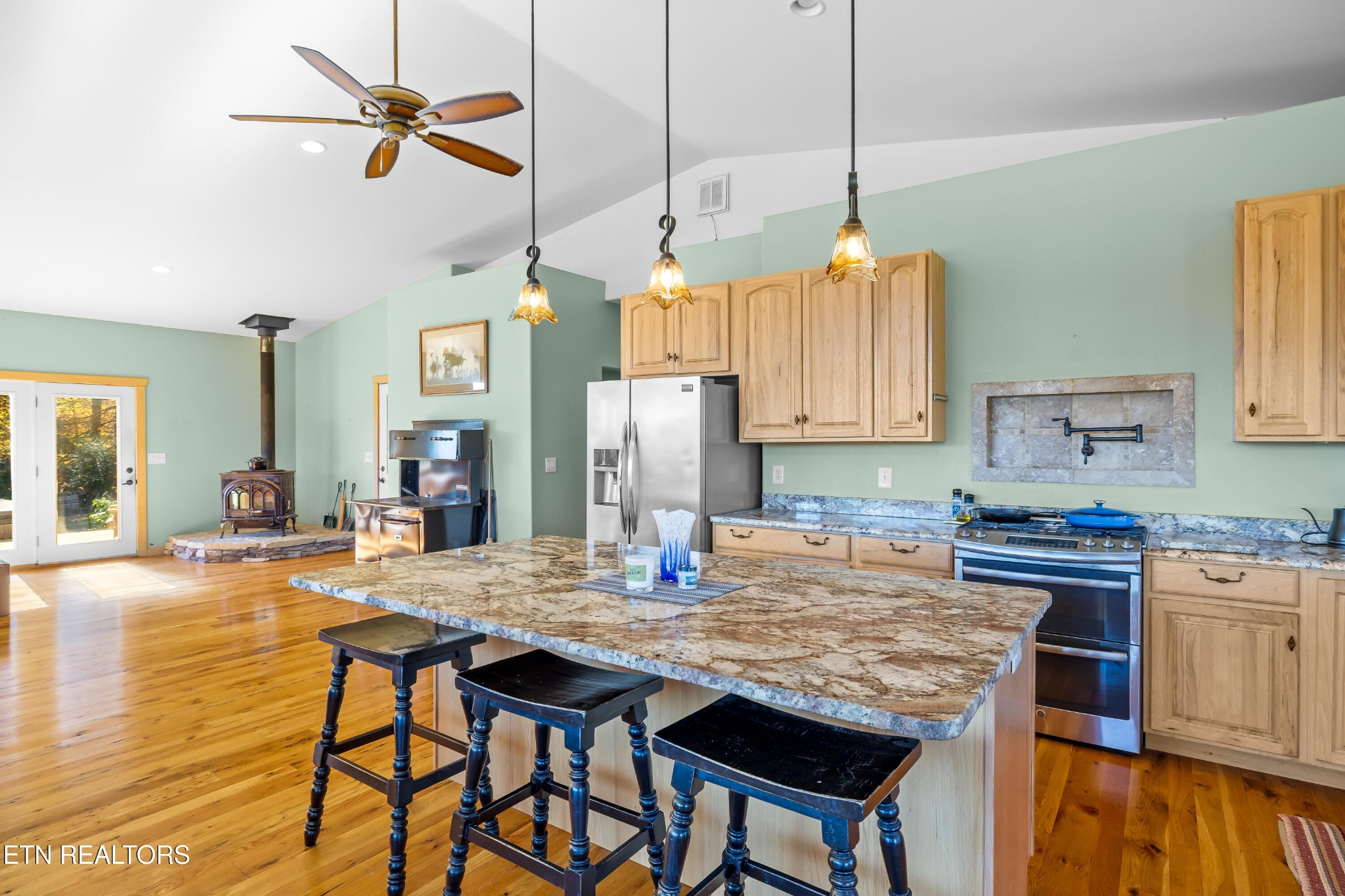 3070 West Fork Road Loudon, TN 37774 - Photo 14 of 48 a kitchen with kitchen island granite countertop a table chairs sink and cabinets