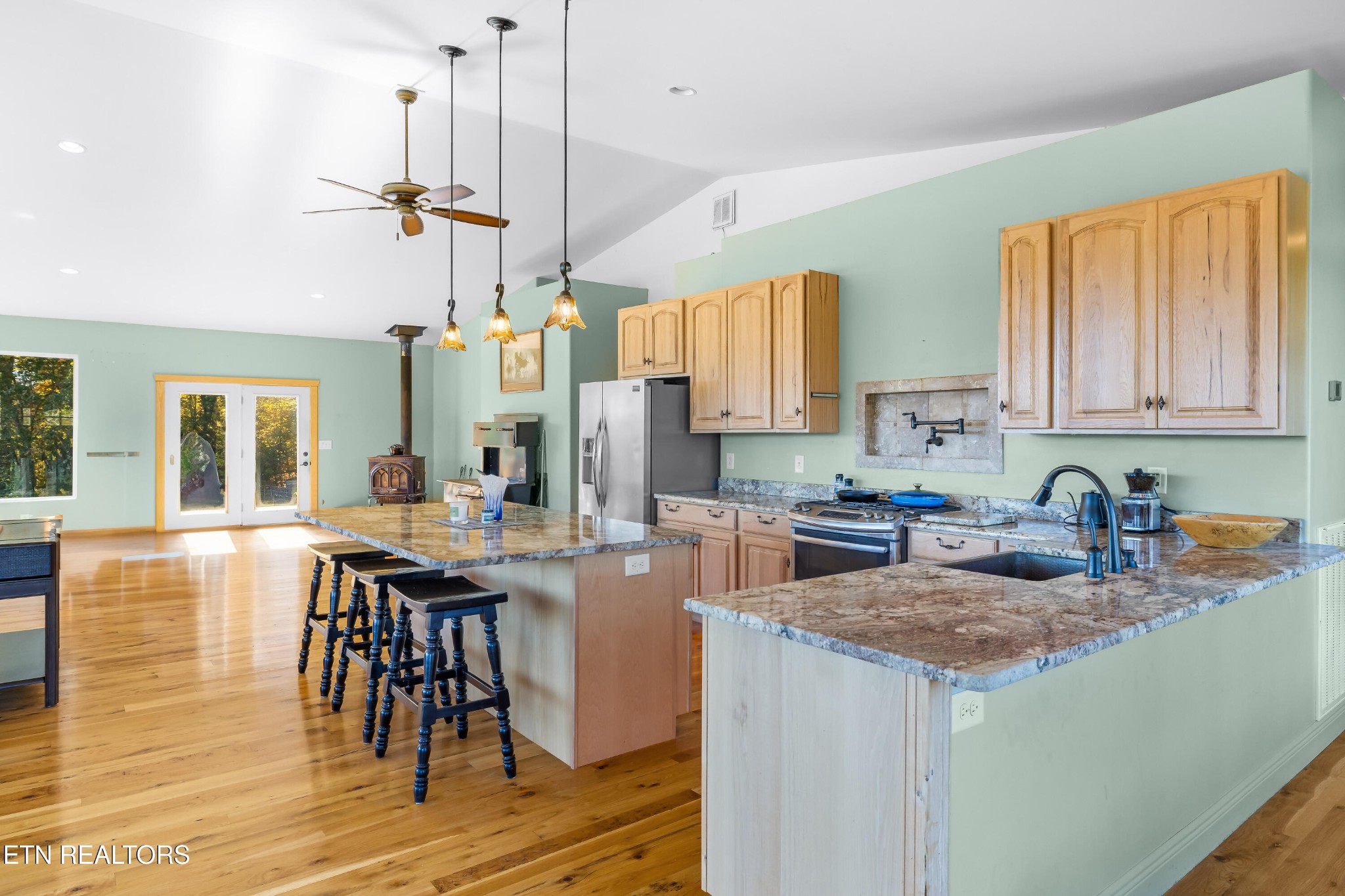 3070 West Fork Road Loudon, TN 37774 - Photo 15 of 48 a kitchen with stainless steel appliances granite countertop a stove top oven a sink a dining table and chairs with wooden floor