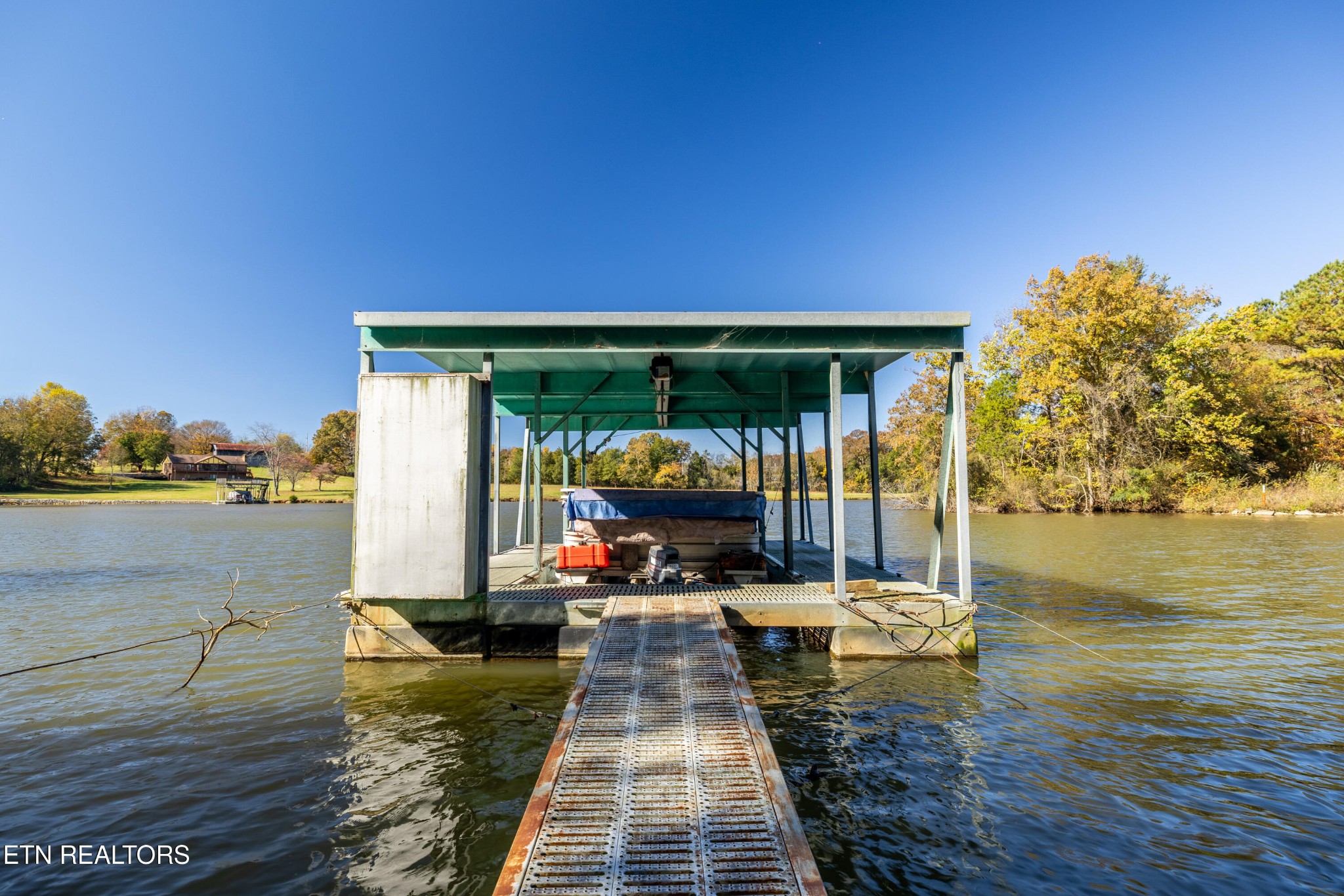 3070 West Fork Road Loudon, TN 37774 - Photo 44 of 48 a view of a patio with dining table and chairs with wooden floor