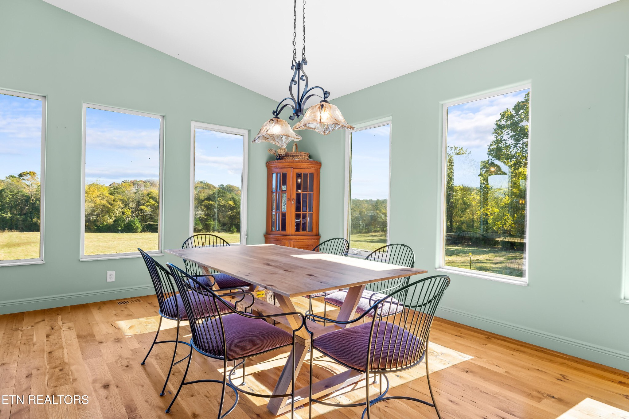 3070 West Fork Road Loudon, TN 37774 - Photo 8 of 48 a dining room with furniture a chandelier and wooden floor