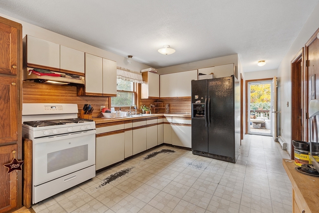 321 Doe Valley Road Athol, MA 01331 - Photo 17 of 31 a kitchen with a refrigerator sink and cabinets