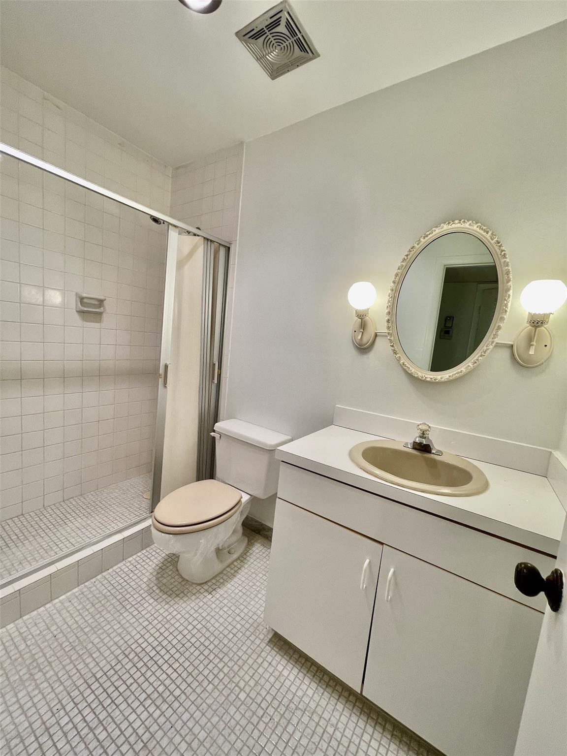 424 North Riverside Drive, Unit 102 Pompano Beach, FL 33062 - Photo 12 of 16 a bathroom with a sink toilet and shower