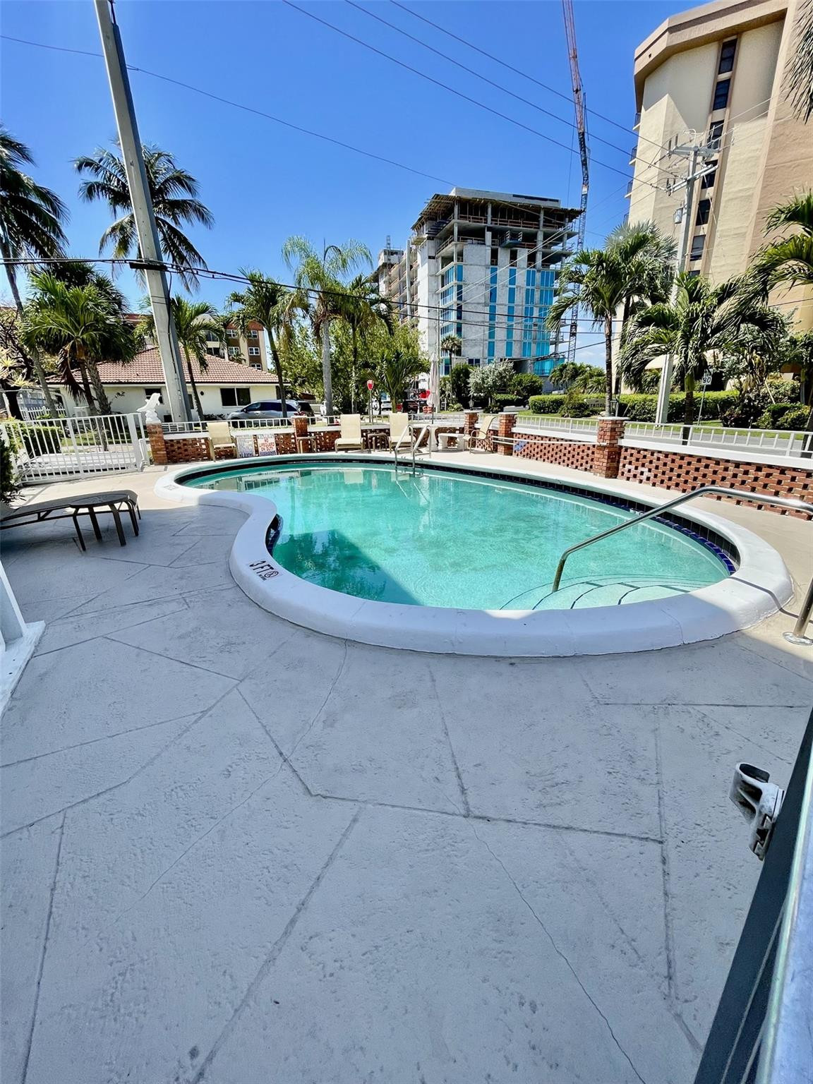 424 North Riverside Drive, Unit 102 Pompano Beach, FL 33062 - Photo 15 of 16 a view of a swimming pool with a lawn chairs