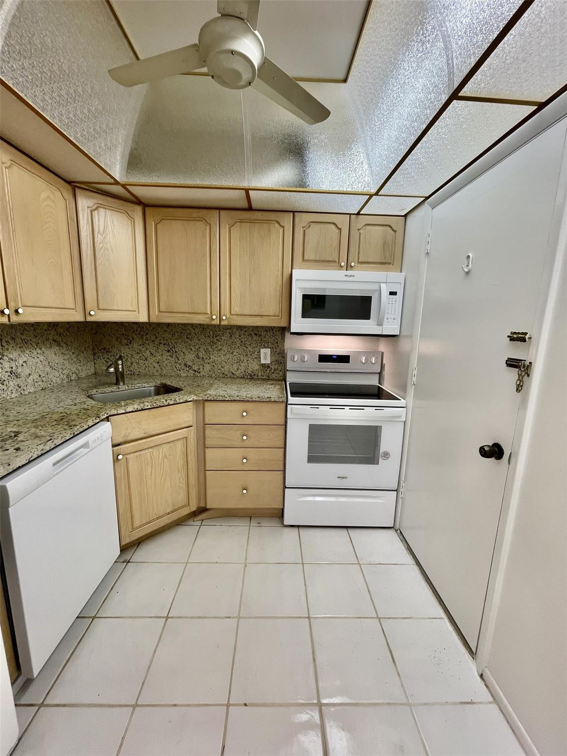 424 North Riverside Drive, Unit 102 Pompano Beach, FL 33062 - Photo 3 of 16 a kitchen with a cabinets and appliances