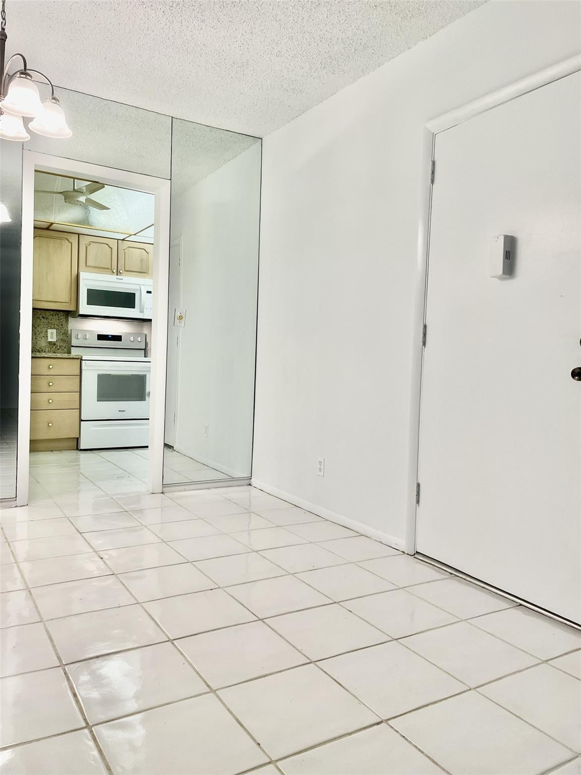 424 North Riverside Drive, Unit 102 Pompano Beach, FL 33062 - Photo 5 of 16 a view of kitchen with refrigerator and cabinets