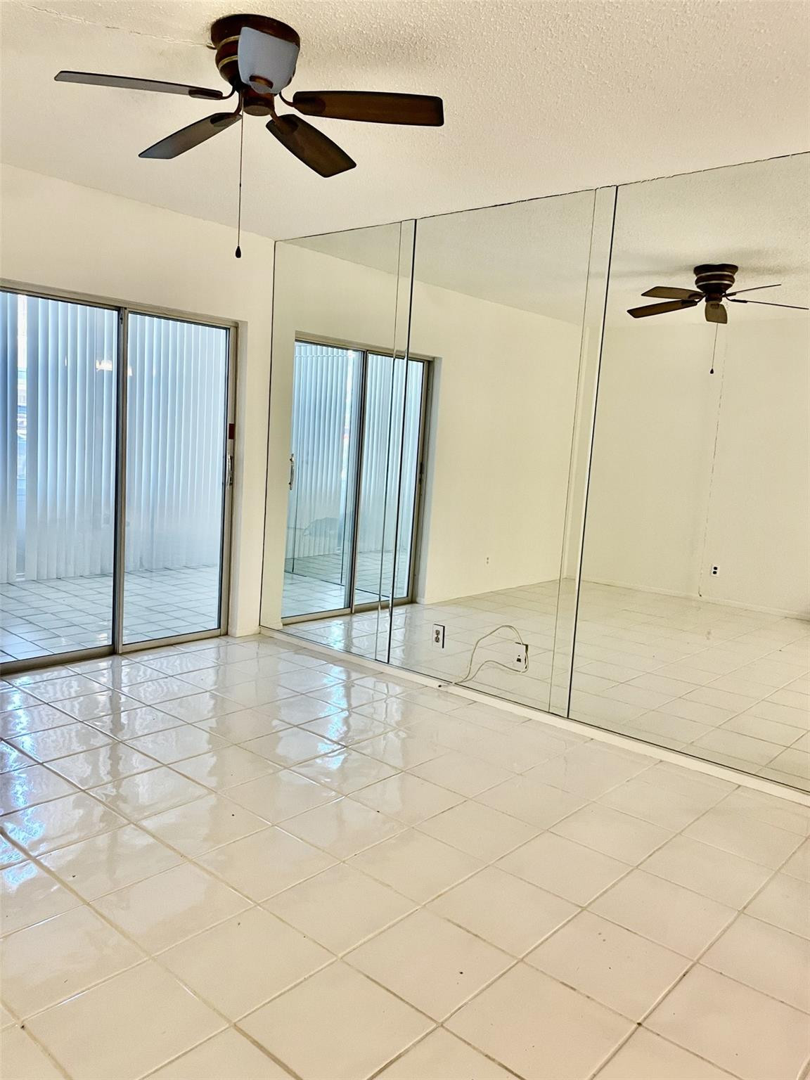 424 North Riverside Drive, Unit 102 Pompano Beach, FL 33062 - Photo 7 of 16 a view of an empty room and window with a ceiling fan