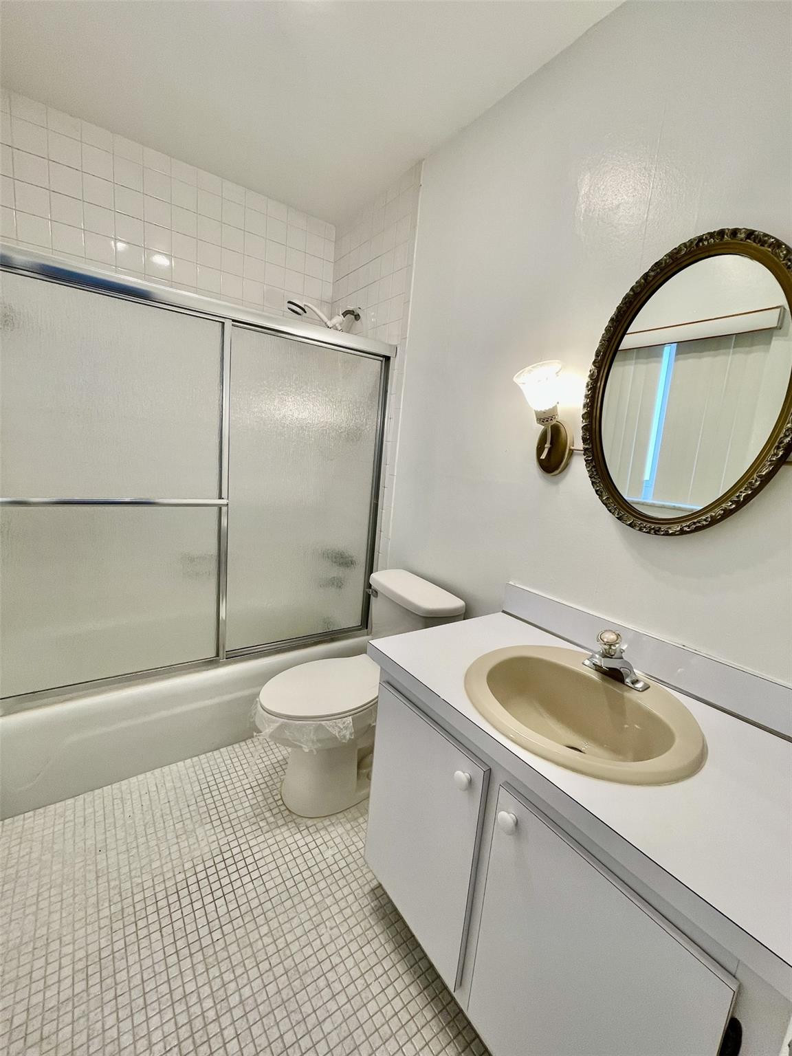 424 North Riverside Drive, Unit 102 Pompano Beach, FL 33062 - Photo 10 of 16 a bathroom with a sink toilet and a mirror