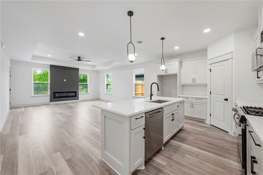 505 Legion Court Bryan, TX 77803 - Photo 7 of 21 a kitchen with stove and wooden floor