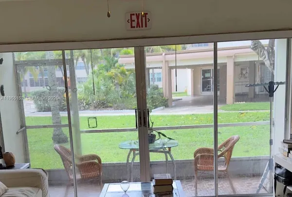 a view of a porch with furniture and backyard