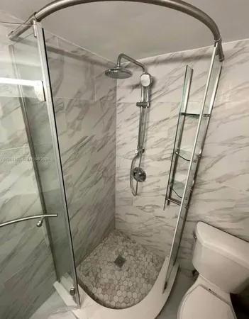 a bathroom with a toilet and shower