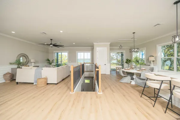 a view of a dining room with furniture a chandelier and wooden floor