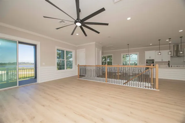 a view of a livingroom with a window and a ceiling fan