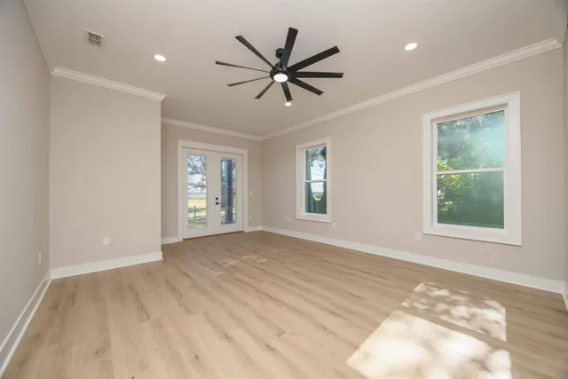 an empty room with a natural light and window