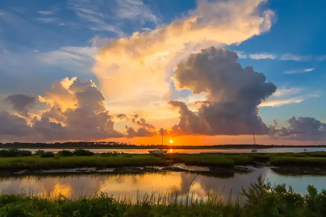a view of a lake with houses in the back