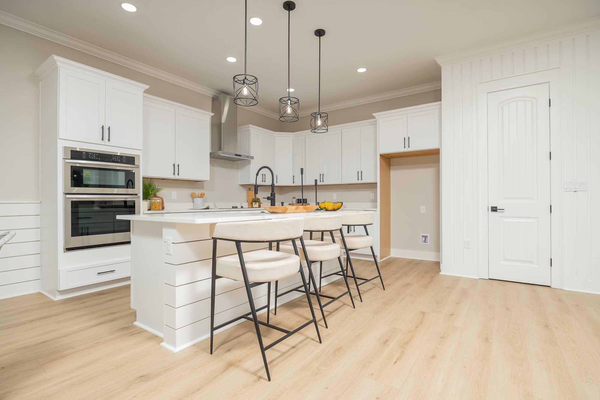 132 Terrapin Road St. Augustine, FL 32086 - Photo 46 of 95 a kitchen with stainless steel appliances kitchen island granite countertop a sink cabinets and wooden floor