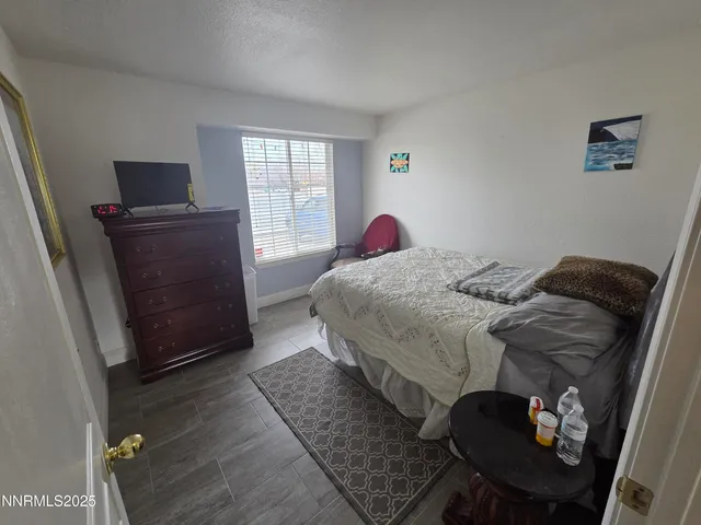 a bedroom with a bed and a dresser in it