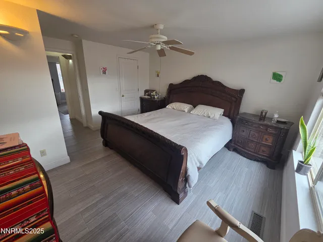 a spacious bedroom with a bed and a dresser