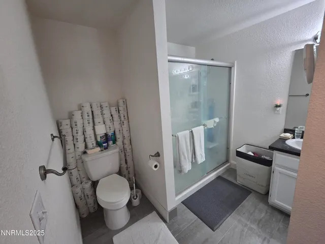 a bathroom with a toilet and a shower
