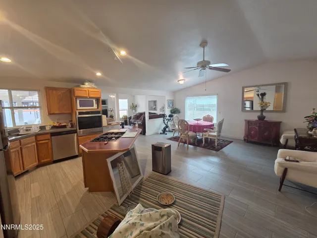 a living room with furniture and kitchen view