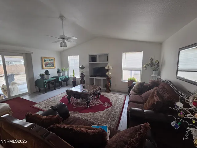 a living room with furniture fireplace and a large window
