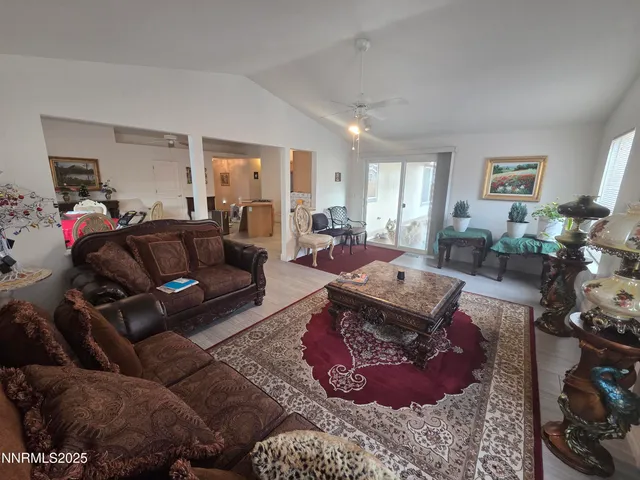 a living room with furniture hard wood floor and a window