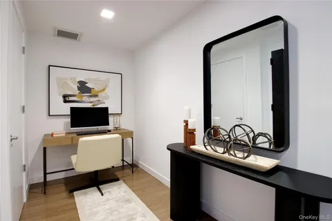 a living room with furniture and a mirror