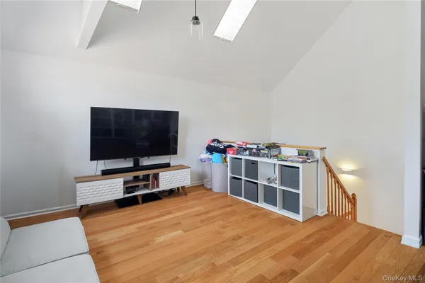 a living room with a flat screen tv and a dresser