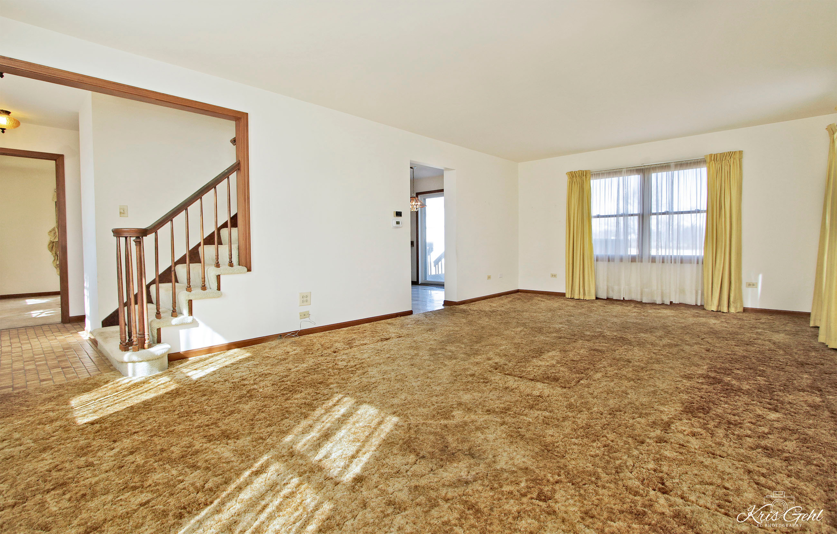 1004 Paddock Road Spring Grove, IL 60081 - Photo 3 of 26 a view of an empty room with wooden floor and stairs