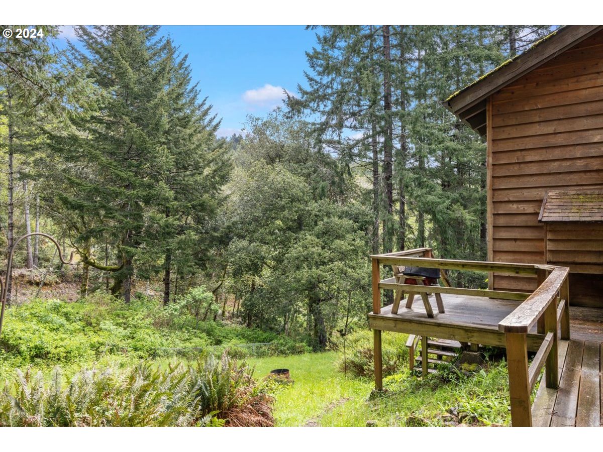 18668 Ranch Road Brookings, OR 97415 - Photo 5 of 48 a backyard of a house with table and chairs