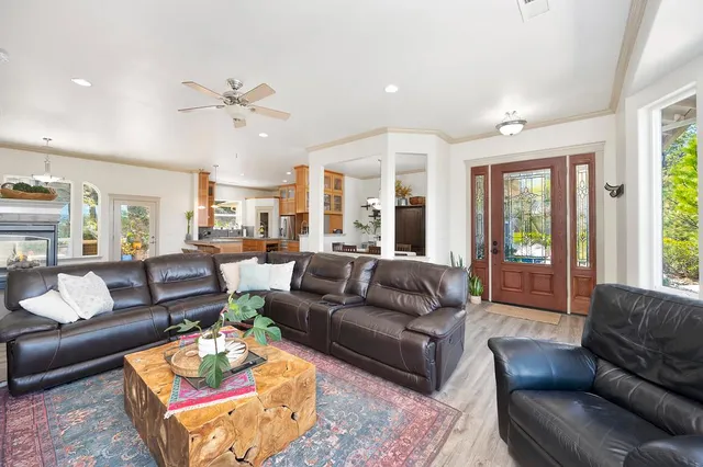 a living room with furniture ceiling fan and a window