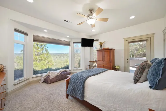 a spacious bedroom with a large bed and a window