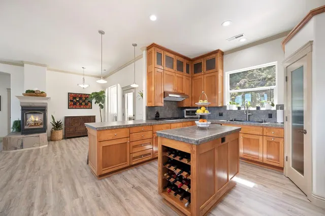 a kitchen with stainless steel appliances granite countertop a stove and a refrigerator