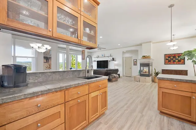 a kitchen with stainless steel appliances granite countertop a oven a stove and a wooden floors