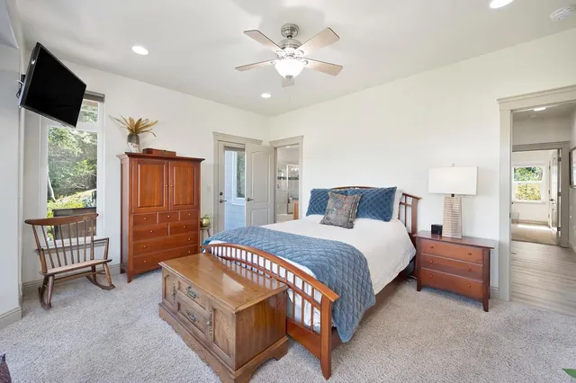 a spacious bedroom with a bed and a chandelier
