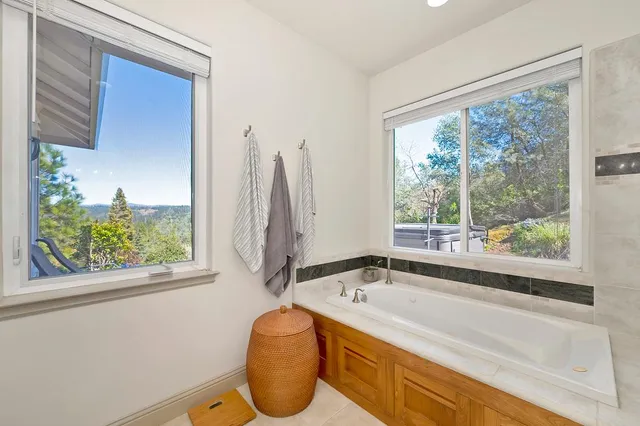 a bathroom with a granite countertop sink and a large window