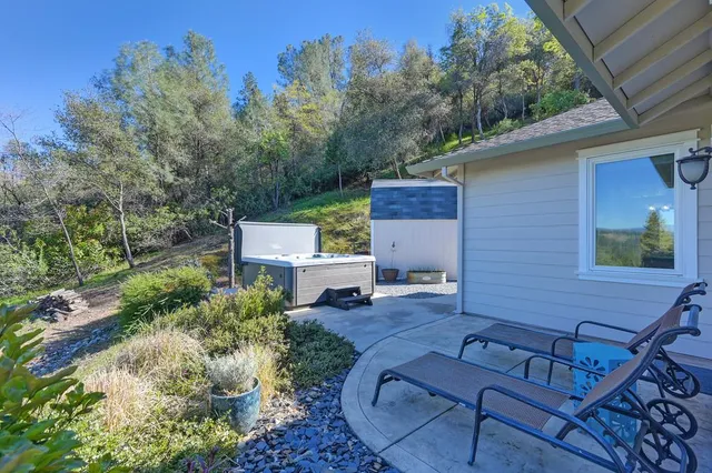 an aerial view of a house with a yard patio and furniture