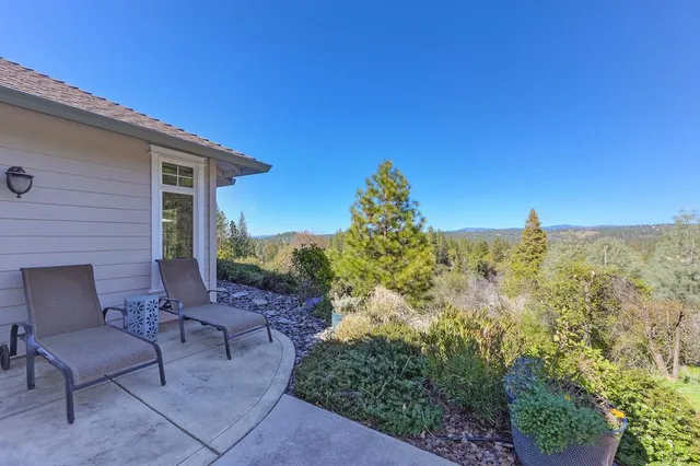 a view of a chairs and table in the patio