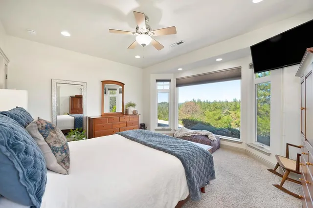 a bedroom with a large bed and a large window