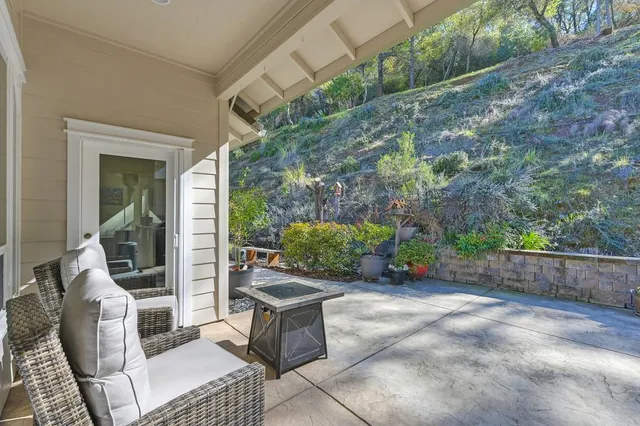 a view of a patio with table and chairs and potted plants